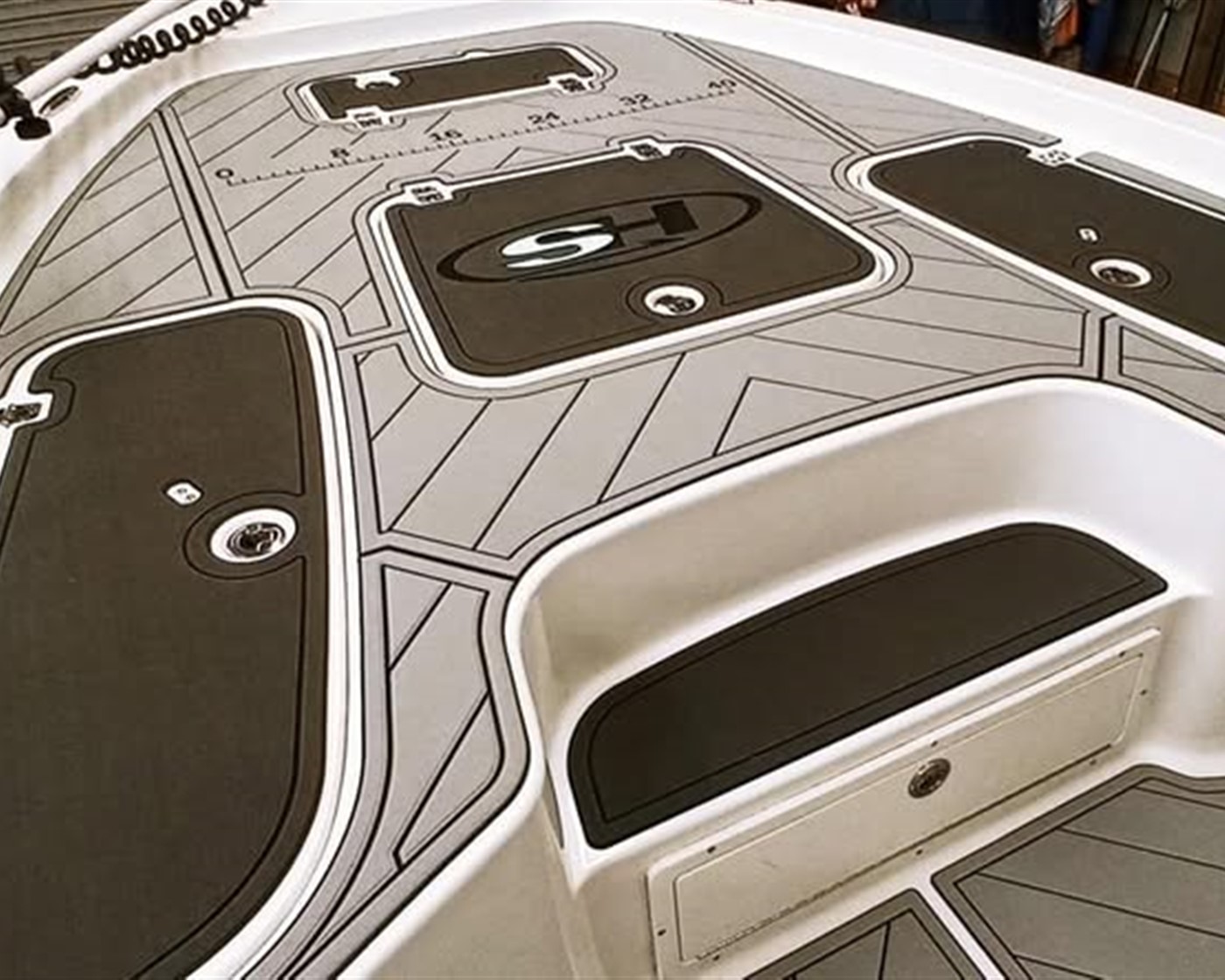 Custom gray and black FlexDek marine mat boat flooring with routed deck panels and measuring detail