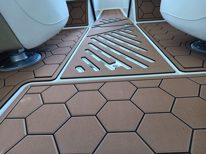 FlexDek teak brown over black boat decking with routed honeycomb pattern